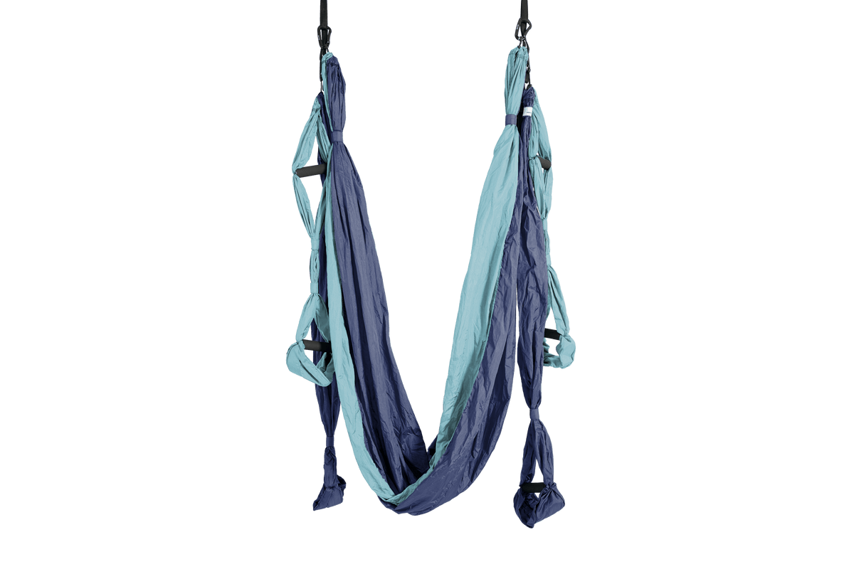 Yoga Hammock in Deep Blue and Ice Blue hanging from two straps, with padded handles on each side