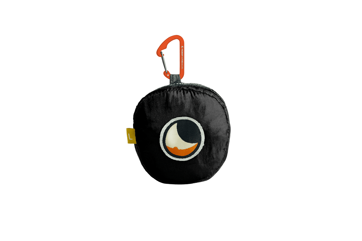 Moon Bag Large folded into its Black pouch with an orange carabiner
