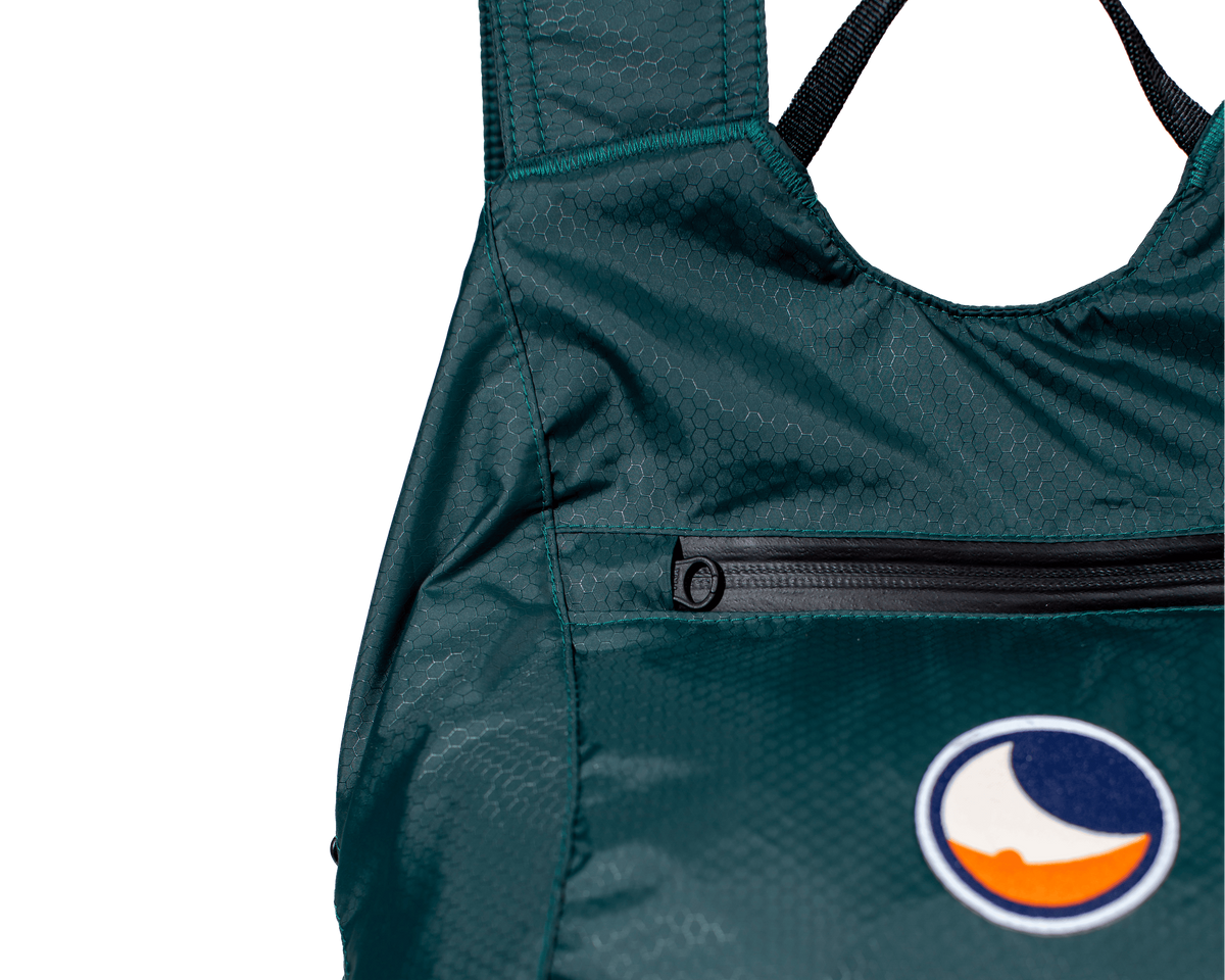 Front zip pocket and moon logo patch on the green Mini Backpack 15L Water Resistant